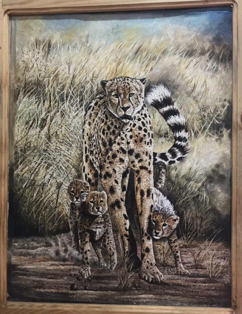 The Embrace of the Savannah: Mother Cheetah and Her Cubs